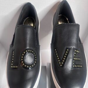 MICHAEL Michael Kors Black Slip-On Shoes with Gold Accents